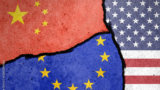 Flags of US, EU and China painted on cracked wall