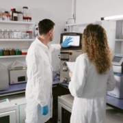 Nouscom employees in front of chromatography machine for purification of its viral vector based products.